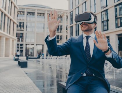 Successful young businessman in formal suit viewing future project in virtual reality