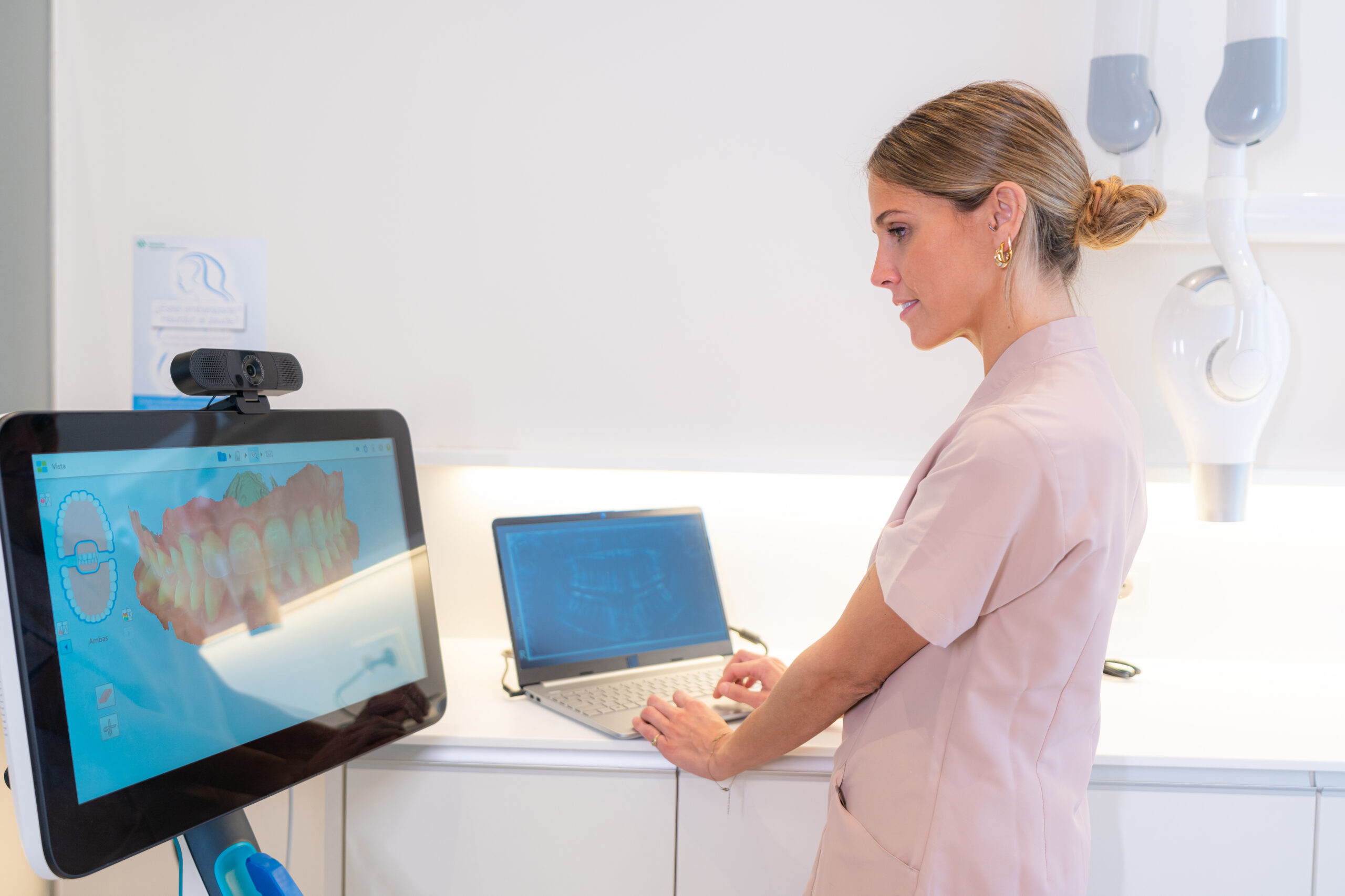 Technician using modern technology in a clinic Technician using modern technology to analyse the scan results in a clinic
